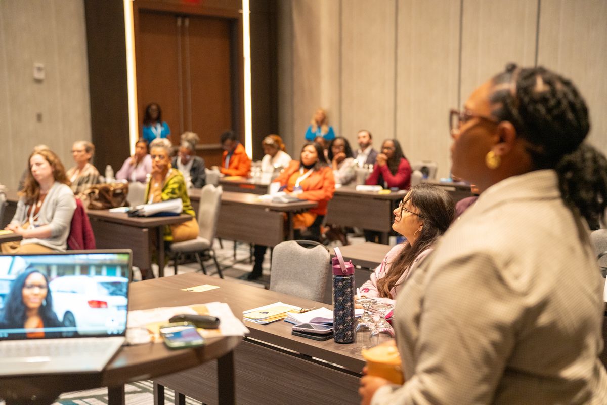 Quaneka Falls presenting to an engaged audience in a conference room