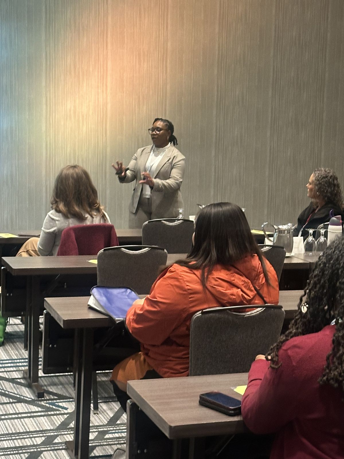 Quaneka Falls presenting to a seated audience at a conference